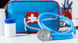 Stethoscope, laptop and pills on the white table