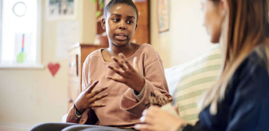 Counseling, child and psychologist woman talking, support and help with problem, mental health or therapy consultation. Listening, empathy and therapist person, african kid and school or life advice